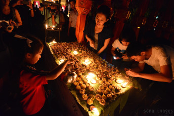 Young girl lighting candles Loy Krathong 2014